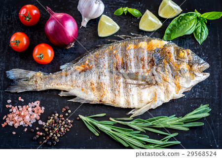 图库照片: grilled dorada fish fresh vegetables and herbs