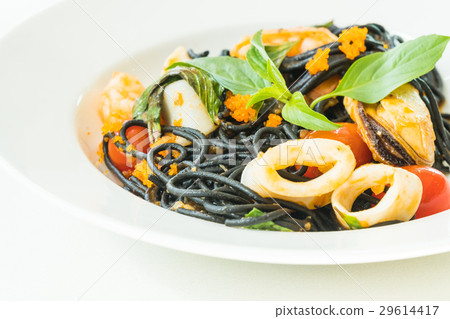 图库照片: black spaghetti with seafood in white plate