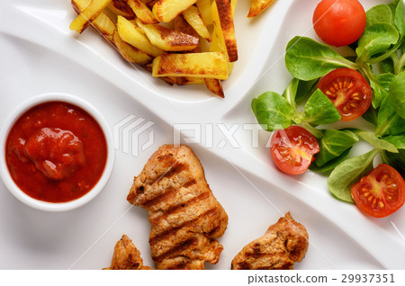 图库照片: grilled pork tenderloin, salad, and fried potatoes