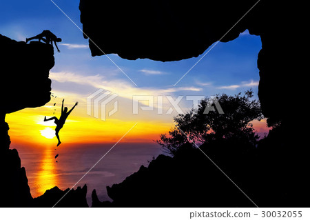 图库照片: man climbing in the cave on the mountain.