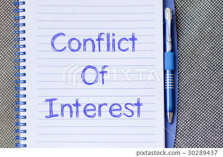 图库照片: conflict of interest write on notebook