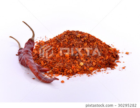 图库照片: dried hot chilli peppers against white background