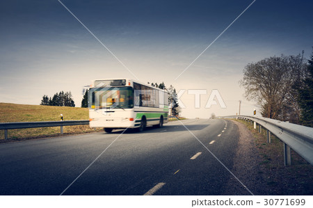 图库照片: bus on asphalt road in beautiful spring day