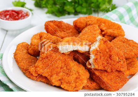 图库照片: crispy chicken nuggets cut in half