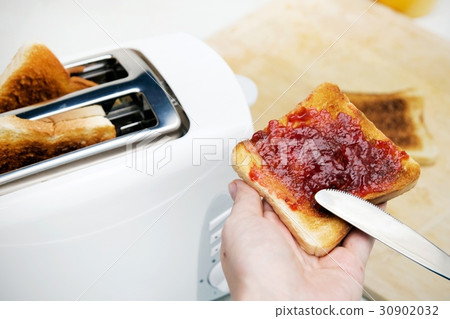 图库照片: preparing toast with jam for breakfast