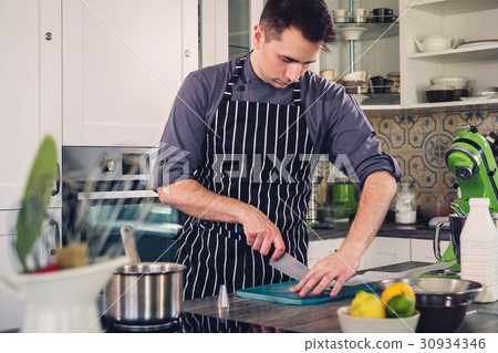 图库照片: chef cook working on a modern kitchen at home