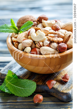 图库照片: mixed nuts in a wooden bowl.