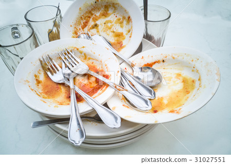 图库照片: pile of dirty oily plates, glass, fork spoons