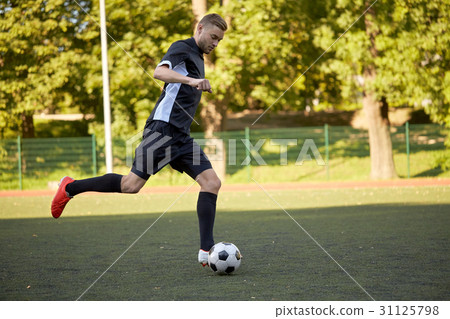 soccer,soccer和football 图库照片: soccer player playing with ball on football field