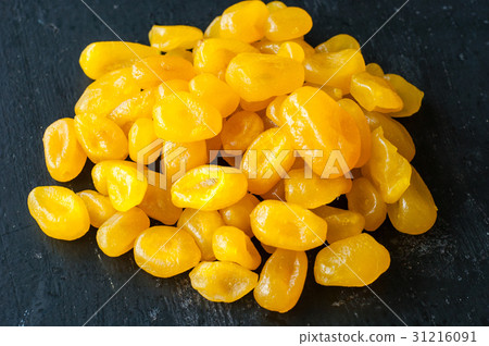 图库照片: dry yellow cumquat on black background