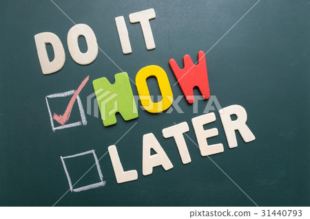 图库照片: do it now or later with checkbox and red check