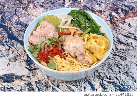 图库照片: boiled noodle and wonton in spicy sour soup.