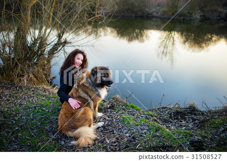 图库照片: woman playing with caucasian shepherd dog, autumn