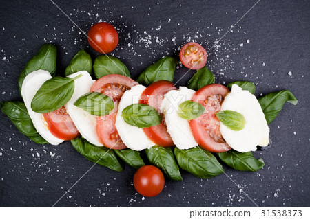 图库照片: caprese salad on slate background