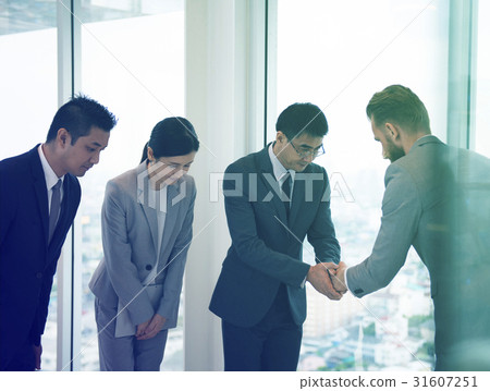 图库照片 business people greeting by handshake and take a bow