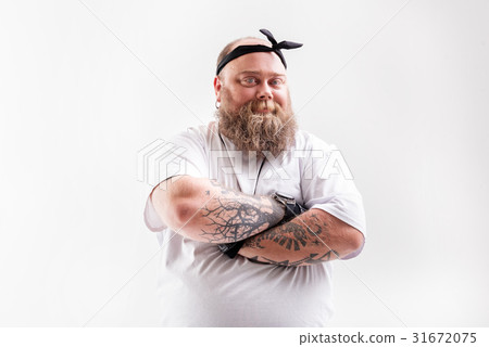 图库照片: cool fat man with beard posing