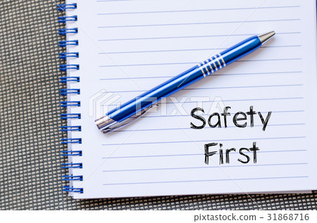 图库照片: safety first text concept on notebook