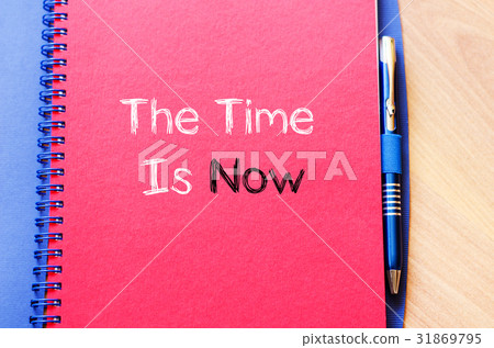 图库照片: the time is now text concept on notebook