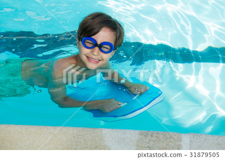 图库照片: smiling boy swimming in the pool