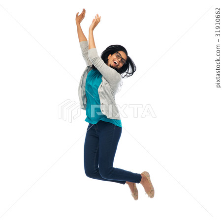 图库照片: smiling young indian woman jumping in air