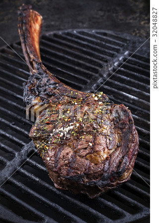 图库照片: barbecue tomahawk steak on grillage