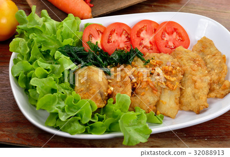 图库照片: fish dish - fried fish fillet with vegetables