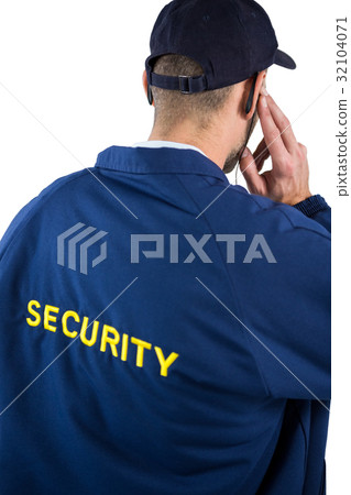 图库照片: rear view of security officer listening to earpiece