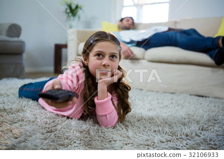 watching,seeingwatching 图库照片: girl watching tv lying on the rug in the living room