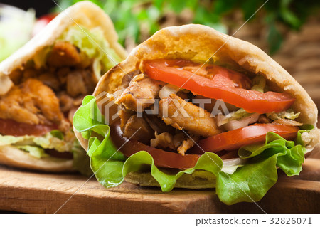 图库照片: doner kebab - fried chicken meat with vegetables