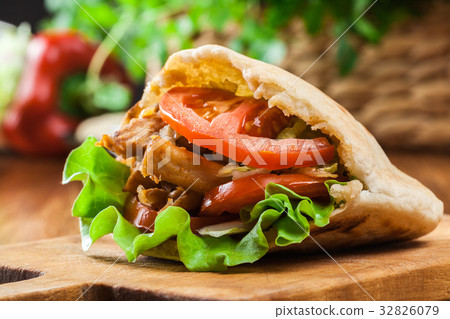 图库照片: doner kebab - fried chicken meat with vegetables