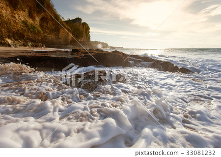 图库照片: ocean wave with foam beating against the rocks at