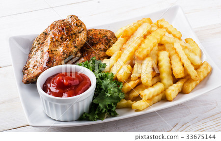 图库照片: grilled chicken steak, french fries and salad