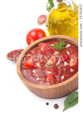 图库照片: tomato sauce in gravy boat on white