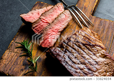 图库照片: sliced grilled medium rare beef steak served on