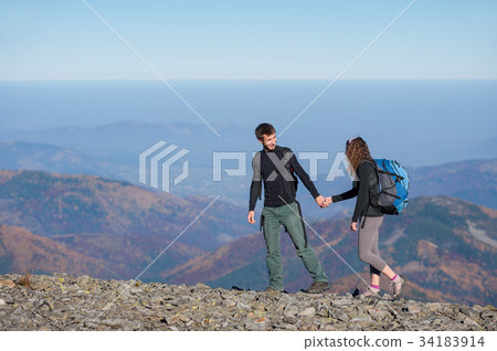 图库照片: happy couple hiking in the beautiful mountains