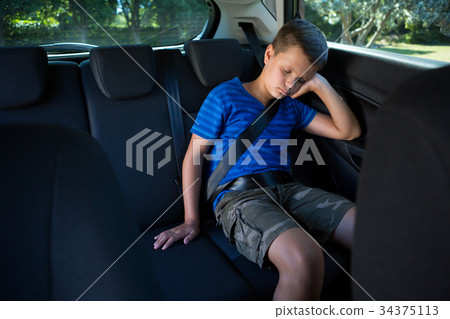 图库照片: teenage boy sleeping in the car