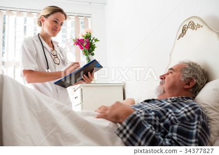 stock photo: doctor examining male patient in nursing home