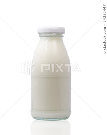 图库照片: glass bottle full of milk on white background