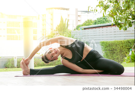 图库照片: young women doing yoga pose at the urban area