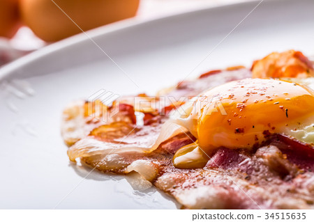 图库照片: ham and eggs. bacon and eggs frying on pan.