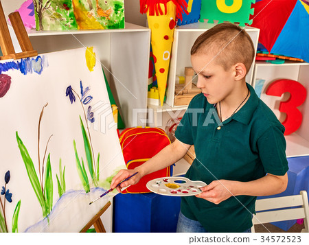 图库照片 child painting finger on easel kid boy learn