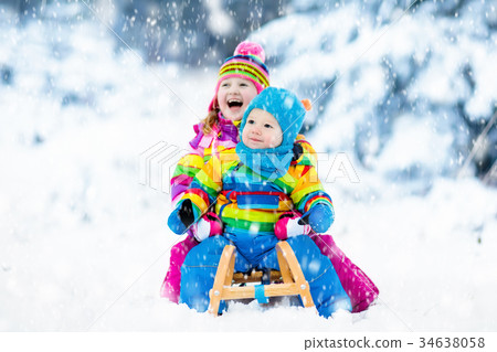 children sledding winter snow