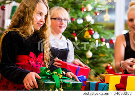 图库照片: mother and children with presents on christmas day