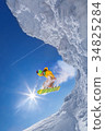 图库照片: skier jumping against blue sky from the rock