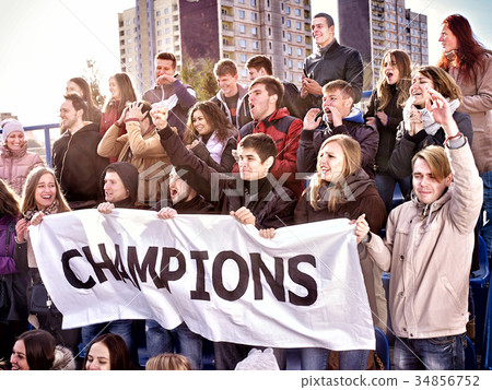cheering,practised 图库照片: cheering fans in stadium holding champion banner.