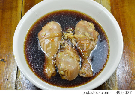 图库照片: boiled chicken leg in fish sauce and chinese herb