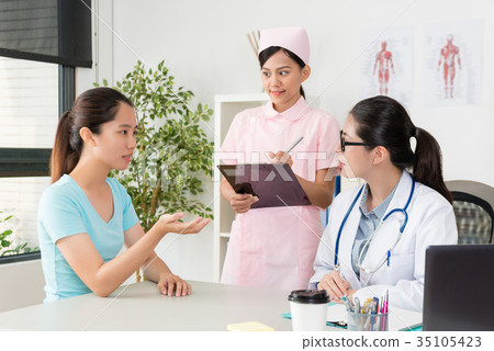 stock photo: nurse standing in office writing medical record