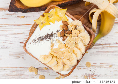 图库照片: banana yoghurt with seeds and cornflakes