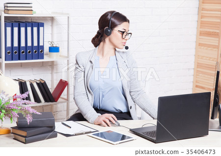 图库照片: call center operator works at the computer in the