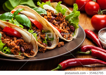 图库照片: mexican tacos with minced meat, beans and spices